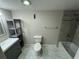Clean bathroom with a bathtub, toilet, and gray tile at 6003 Village Cir # Ge, Orlando, FL 32822