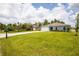 New construction home with gray siding, white garage door, and a grassy yard at 15031 Sw 28Th Terrace Rd, Ocala, FL 34473