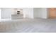 Open concept living area with kitchen island, white cabinets, and gray carpeting at 15031 Sw 28Th Terrace Rd, Ocala, FL 34473