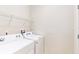 Functional laundry room with washer and dryer, and overhead shelving at 1586 Lima Ave, Kissimmee, FL 34747