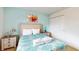 Bedroom with queen-size bed, light teal walls, and window at 1586 Lima Ave, Kissimmee, FL 34747