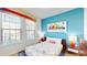 Cozy bedroom with a full-size bed, colorful decor, and plenty of natural light at 1586 Lima Ave, Kissimmee, FL 34747
