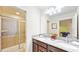 Bathroom with double vanity, granite countertop, and shower at 1586 Lima Ave, Kissimmee, FL 34747