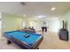 Fun game room with pool table, foosball, and comfortable seating at 1586 Lima Ave, Kissimmee, FL 34747