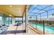 Screened pool area with patio furniture and grill at 1586 Lima Ave, Kissimmee, FL 34747