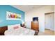 Guest bedroom with full bed, dresser, and a modern aesthetic at 1586 Lima Ave, Kissimmee, FL 34747