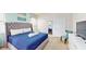 Spacious main bedroom with plush bed, ample natural light, and en-suite bathroom access at 1586 Lima Ave, Kissimmee, FL 34747