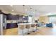 Open kitchen with island, granite countertops, stainless steel appliances, and dark cabinetry at 1586 Lima Ave, Kissimmee, FL 34747