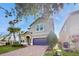 Two-story house with a two-car garage and palm trees at 1586 Lima Ave, Kissimmee, FL 34747