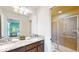 Bathroom with granite countertop, double sinks, and shower at 1586 Lima Ave, Kissimmee, FL 34747