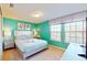 Bright bedroom with a king-size bed and teal walls at 1586 Lima Ave, Kissimmee, FL 34747