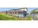 Landscaped backyard with a screened pool and fence at 1586 Lima Ave, Kissimmee, FL 34747