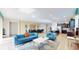 Open concept living space with teal sofas and a dining table at 1586 Lima Ave, Kissimmee, FL 34747