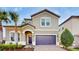 Two-story house with a two-car garage and palm trees at 1586 Lima Ave, Kissimmee, FL 34747