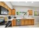 Kitchen features modern appliances and wood cabinets at 2524 Dover Glen Cir, Orlando, FL 32828