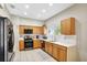 Kitchen with stainless steel appliances and light wood cabinets at 2524 Dover Glen Cir, Orlando, FL 32828