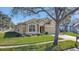 Tan two-story house with a two-car garage and well-manicured lawn at 2524 Dover Glen Cir, Orlando, FL 32828
