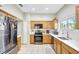 Kitchen with stainless steel appliances and light wood cabinets at 2524 Dover Glen Cir, Orlando, FL 32828