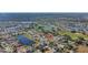 Aerial view showing home's location in a neighborhood with a golf course and lake at 2524 Dover Glen Cir, Orlando, FL 32828