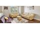 Spacious living room featuring light leather sofas and dark wood floors at 2524 Dover Glen Cir, Orlando, FL 32828