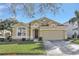 Tan house with 2-car garage, great curb appeal at 2524 Dover Glen Cir, Orlando, FL 32828