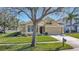 Attractive tan house with a well-manicured lawn and driveway at 2524 Dover Glen Cir, Orlando, FL 32828
