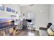 Bright home office with a desk, comfortable sofa, and large TV at 2524 Dover Glen Cir, Orlando, FL 32828