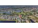Aerial view of house nestled in a community near a golf course and lake at 2524 Dover Glen Cir, Orlando, FL 32828