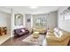 Spacious living room featuring light leather sofas and dark wood floors at 2524 Dover Glen Cir, Orlando, FL 32828