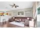 Sunlit living room with hardwood floors and a large sectional sofa at 2524 Dover Glen Cir, Orlando, FL 32828
