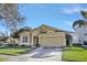 Tan two-story house with a two-car garage and well-manicured lawn at 2524 Dover Glen Cir, Orlando, FL 32828