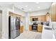 Kitchen with stainless steel appliances and light wood cabinets at 2524 Dover Glen Cir, Orlando, FL 32828
