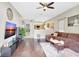 Spacious living room featuring hardwood floors and a large sectional sofa at 2524 Dover Glen Cir, Orlando, FL 32828