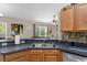 Modern kitchen features stainless steel appliances and dark countertops at 33 Fisher Run Ter, Ocklawaha, FL 32179