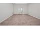 Spacious carpeted bedroom with double doors leading to a balcony at 3860 Rose Malllow Dr, Kissimmee, FL 34746