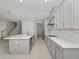 Modern kitchen with gray cabinets, white countertops, and stainless steel appliances at 3860 Rose Malllow Dr, Kissimmee, FL 34746