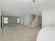 Bright and spacious living room with tile floors and staircase at 3860 Rose Malllow Dr, Kissimmee, FL 34746