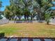 Large backyard with mature trees and a grassy area at 3860 Rose Malllow Dr, Kissimmee, FL 34746