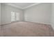Main bedroom with carpeted floors and access to patio at 3860 Rose Malllow Dr, Kissimmee, FL 34746