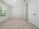 Simple bedroom with light gray walls, wood-look floors, and double doors at 3860 Rose Malllow Dr, Kissimmee, FL 34746