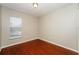 Simple bedroom with wood-look floors and window with blinds at 3229 Clewiston St, Deltona, FL 32738