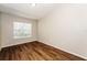 Simple bedroom with wood-look floors and window with blinds at 3229 Clewiston St, Deltona, FL 32738