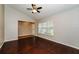 Bright living room featuring dark hardwood floors and a ceiling fan at 3229 Clewiston St, Deltona, FL 32738