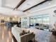 Open living room and kitchen with hardwood floors, vaulted ceilings, and a large sliding glass door at 15680 Panther Lake Dr, Winter Garden, FL 34787