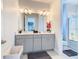 Modern bathroom with double vanity and large mirror at 15680 Panther Lake Dr, Winter Garden, FL 34787