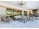 Covered patio with comfortable seating and views of the pool and backyard at 15680 Panther Lake Dr, Winter Garden, FL 34787