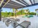 Relaxing pool area with patio furniture under a pergola at 15680 Panther Lake Dr, Winter Garden, FL 34787