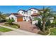 Two-story home with tile roof, solar panels and brick driveway at 15680 Panther Lake Dr, Winter Garden, FL 34787