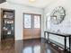 Bright entryway with hardwood floors, built-in shelves, and a large mirror at 15680 Panther Lake Dr, Winter Garden, FL 34787