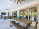 Covered patio with seating area, TV, and access to the pool at 15680 Panther Lake Dr, Winter Garden, FL 34787
